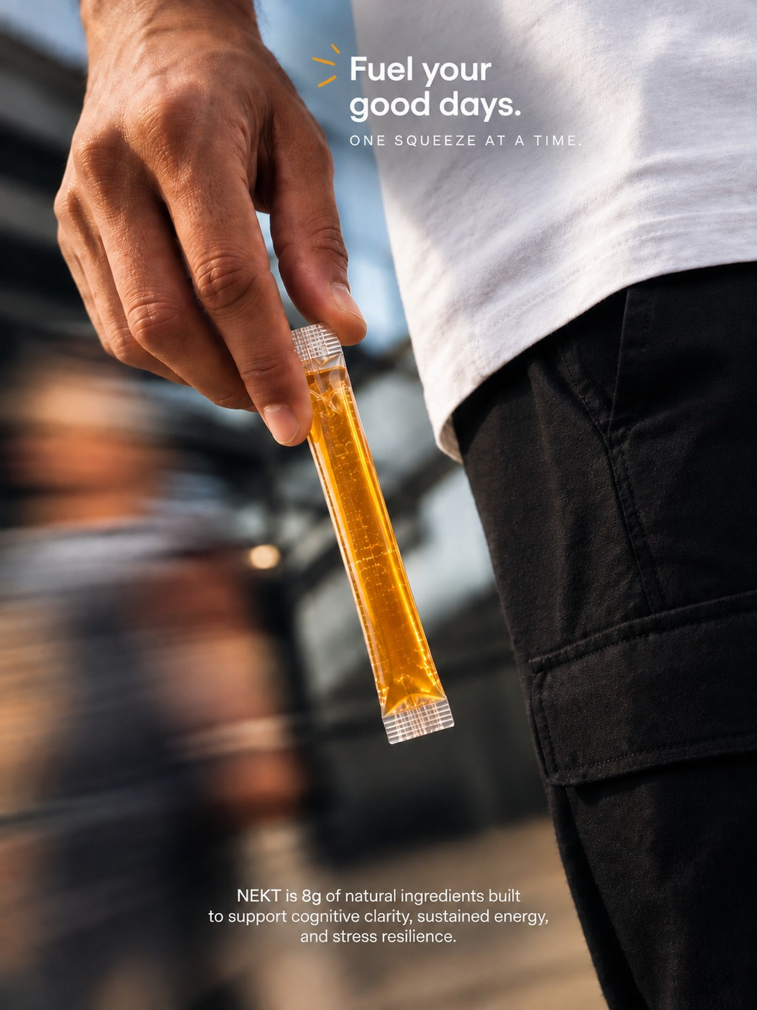 A hand holding a NEKT sachet mid-stride